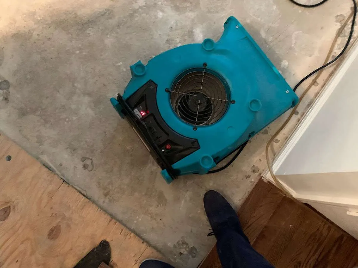 Air mover drying subfloor during Commercial Water Damage Restoration in Campton Hills